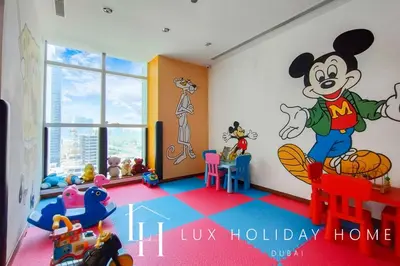 a room with a mickey mouse mural on the wall at LUX The Bonnington JLT Suite in Dubai