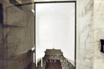 a glass door with white chairs in a room at LUX The Bonnington JLT Suite in Dubai