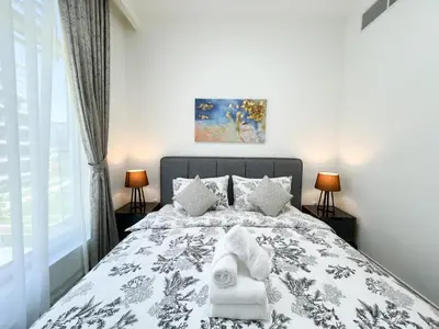 a bedroom with a bed with towels on it at Luxurious New Brand 2Br at Mulberry 2 at Park Heights Building A2 - Dubai Hills in Dubai
