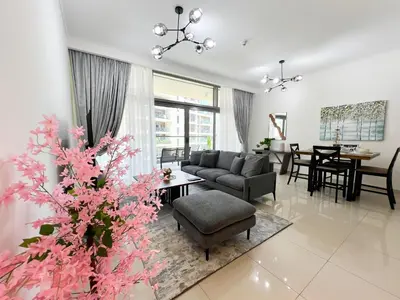 a living room with a couch and a table at Luxurious New Brand 2Br at Mulberry 2 at Park Heights Building A2 - Dubai Hills in Dubai