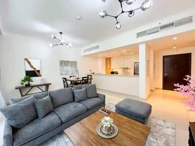 a living room with a couch and a table at Luxurious New Brand 2Br at Mulberry 2 at Park Heights Building A2 - Dubai Hills in Dubai