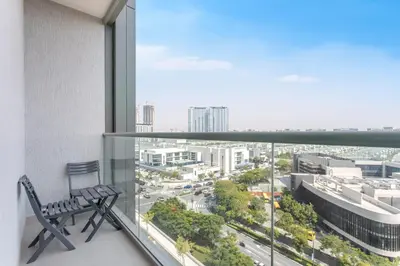 a chair on a balcony with a view of a city at STAY BY LATINEM Luxury 1BR Holiday Home CVR A609 near Burj Khalifa in Dubai