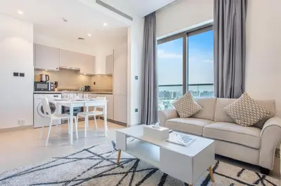 a living room with a couch and a table at STAY BY LATINEM Luxury 1BR Holiday Home CVR A609 near Burj Khalifa in Dubai
