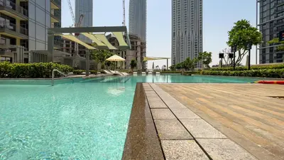 a swimming pool in a city with tall buildings at GLOBALSTAY Creek Rise Tower Elegant Apartments in Dubai