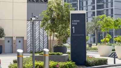 a sign that reads check rise in a city at GLOBALSTAY Creek Rise Tower Elegant Apartments in Dubai