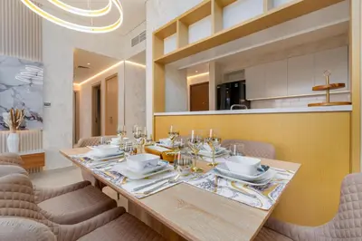 a dining room with a wooden table and chairs at GLOBALSTAY Creek Rise Tower Elegant Apartments in Dubai