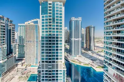 a city skyline with tall buildings and a river at HAVN - Studio with Lake Views in Dubai Gate, JLT in Dubai