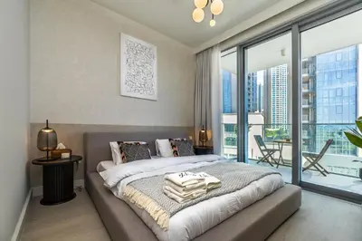 a bedroom with a bed and a large window at Burj Khalifa view & Creek sea view in Dubai