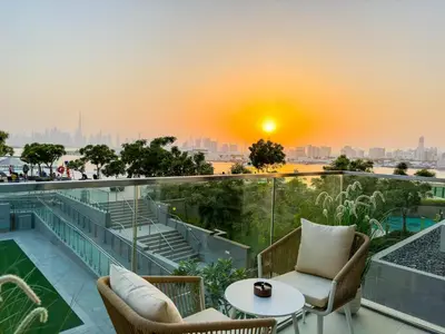 a balcony with a view of the city at sunset at Burj Khalifa view & Creek sea view in Dubai