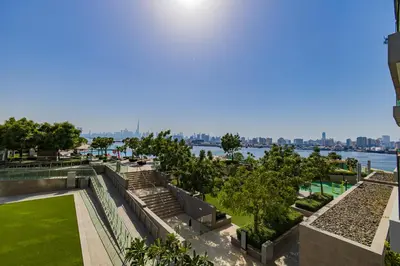 a view of a park with a view of the water at Burj Khalifa view & Creek sea view in Dubai