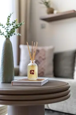 a coffee table with a book and a vase on it at GuestReady - Downtown Dubai luxurious living in Dubai