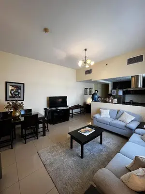 a living room with a couch and a table at Ashri HH, Studio in JVC in Dubai
