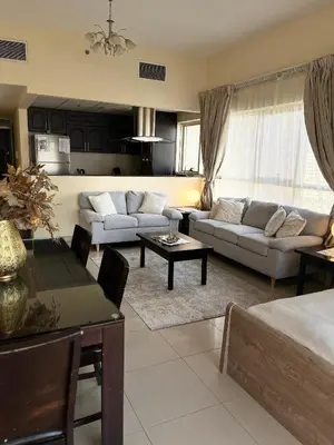 a living room with two couches and a table at Ashri HH, Studio in JVC in Dubai