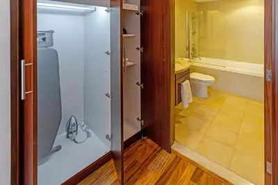 a bathroom with a toilet and a glass door at City skyline view I Super-fast Wi-fi I Downtown in Dubai