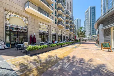 a shopping mall with tables and chairs in a city at City skyline view I Super-fast Wi-fi I Downtown in Dubai