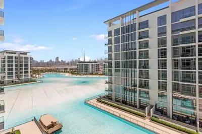 an aerial view of a building with a swimming pool at Premium 1-BR with Exquisite Layout in District One in Dubai