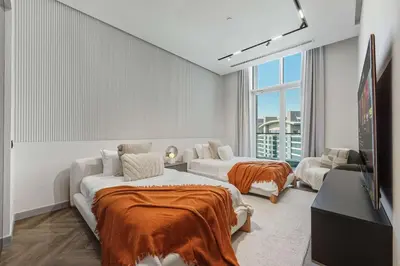 a living room with two beds and a couch at Palm Penthouse Sky Villa - Vast Terrace & Jacuzzi by Exclusive Holiday Homes in Dubai