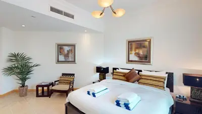 a bedroom with a large bed in a room at Dabas Palm Shores Elegant Four Beds in Dubai