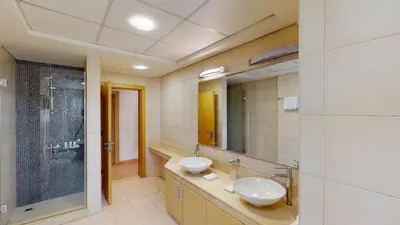 a bathroom with two sinks and a large mirror at Dabas Palm Shores Elegant Four Beds in Dubai