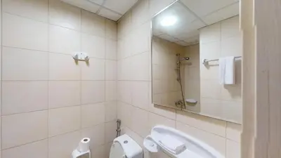 a bathroom with a sink and a toilet and a mirror at Dabas Palm Shores Elegant Four Beds in Dubai