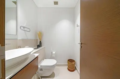 a bathroom with a white toilet and a sink at Experience City Walk - Spacious Haven - 2 Bedroom plus Maid's Room in Dubai