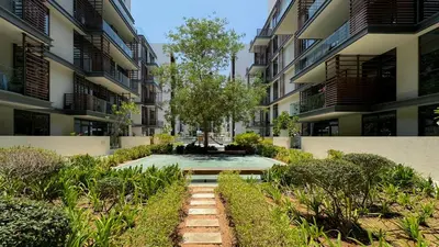 a courtyard of an apartment building with a fountain at Experience City Walk - Spacious Haven - 2 Bedroom plus Maid's Room in Dubai