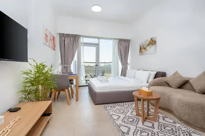 a living room with a couch and a table at Nice studio in Al Furjan - Dubai in Dubai