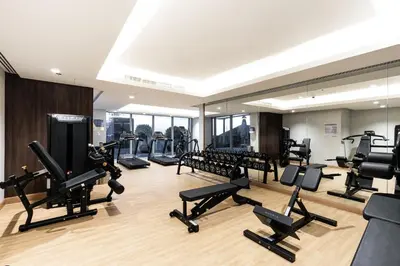 a gym with treadmills and elliptical machines at GLOBALSTAY J One Tower Apartments at Pearl of UAE in Dubai