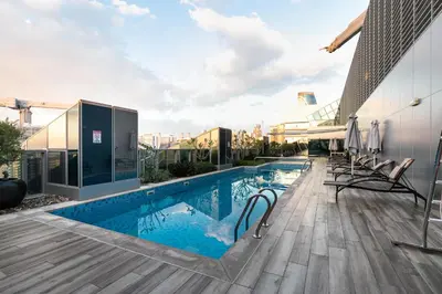 a swimming pool on the roof of a building at GLOBALSTAY J One Tower Apartments at Pearl of UAE in Dubai