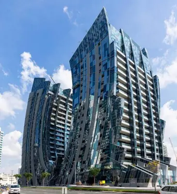 a tall building with glass windows in a city at GLOBALSTAY J One Tower Apartments at Pearl of UAE in Dubai