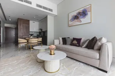 a living room with a couch and two tables at GLOBALSTAY J One Tower Apartments at Pearl of UAE in Dubai
