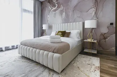 a bedroom with a large white bed with two lamps at GLOBALSTAY J One Tower Apartments at Pearl of UAE in Dubai
