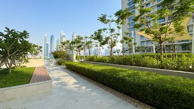 a walkway in a city with buildings and trees at Beachfront 2-BDR, High floor, Sea and Palm View, Beach Access in Dubai