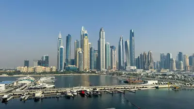 a view of a large city with boats in the water at Beachfront 2-BDR, High floor, Sea and Palm View, Beach Access in Dubai