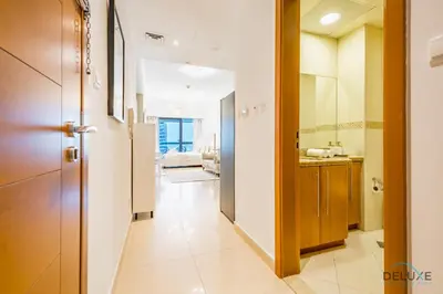 a hallway leading to a bathroom with a sink at Unbeatable Price, Luxury 1BR, Limited Time Offer by Deluxe Holiday Homes in Dubai