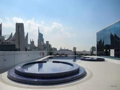 a large pool of water on a building with a city at Unbeatable Price, Luxury 1BR, Limited Time Offer by Deluxe Holiday Homes in Dubai