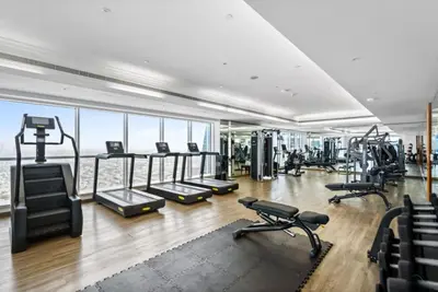 a gym with treadmills and exercise equipment in a building at Unbeatable Price, Luxury 1BR, Limited Time Offer by Deluxe Holiday Homes in Dubai