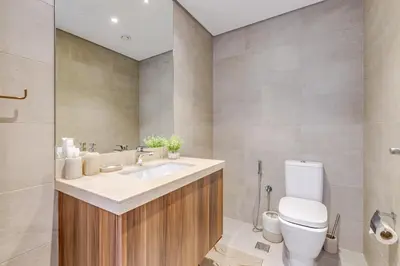 a bathroom with a white toilet and a sink at GLOBALSTAY DAMAC Majestine Apartments in Dubai