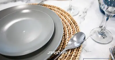 a plate and a spoon on a table at Stunning Luxury 1BR - Modern with Pool View - JVC in Dubai
