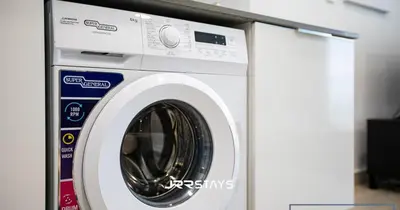 a white washing machine in a room at Stunning Luxury 1BR - Modern with Pool View - JVC in Dubai