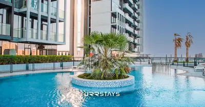 a swimming pool in the middle of a building at Stunning Luxury 1BR - Modern with Pool View - JVC in Dubai