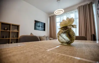 a vase with a flower sitting on top of a table at Stylish 2bd with great view in Marina View Tower in Dubai