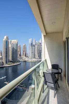 a balcony with a table and chairs and a view of the city at Stylish 2bd with great view in Marina View Tower in Dubai