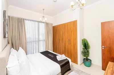 a bedroom with a bed and a potted plant at Escape24 Cozy 1BR near Dubai Malll & Burj Khalifa in Dubai