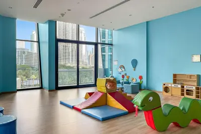 a childs room with a dinosaur themed play area at Luxe 3BR Retreat, Balcony Burj & Fountain Views, Prime Downtown Stay in Dubai