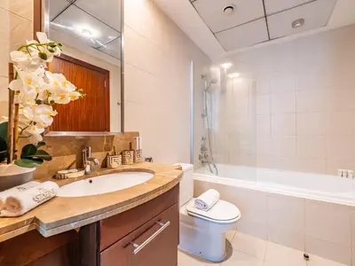 a bathroom with a sink and a tub and a toilet at Downtown Luxury Living -1BR-Standpoint Tower A in Dubai