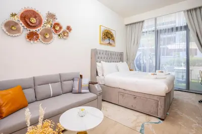 a living room with a couch and a bed at Zapbed House - Modern Studio in Azizi Riviera 27 Meydan One in Dubai