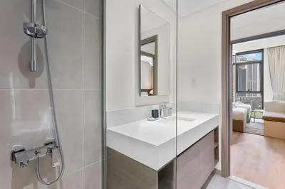 a bathroom with a white sink and a shower at Luxury 2 bedroom in Dubai Creek Harbour- Suiteable in Dubai