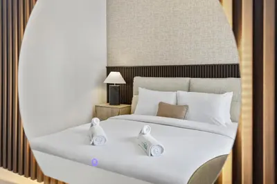 a bedroom with a white bed with two towels on it at Luxury 2 bedroom in Dubai Creek Harbour- Suiteable in Dubai