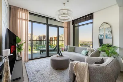 a living room with a couch and a table at GuestReady - Upscale living at Palace Residence in Dubai